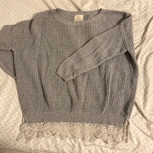 Heather grey knit sweater with lace detailing at the bottom
